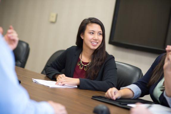 Graduate business students work together to design a funding proposal 